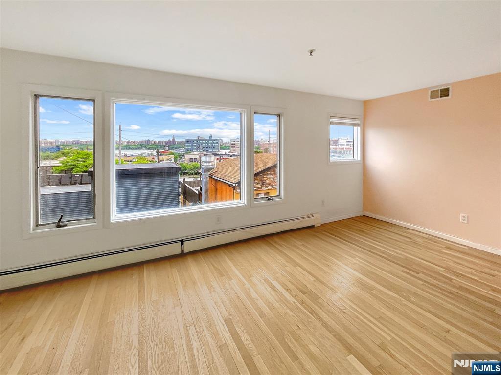 wooden floor in an empty room with a window