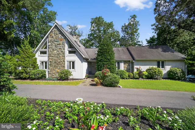 a front view of a house with a yard and potted plants