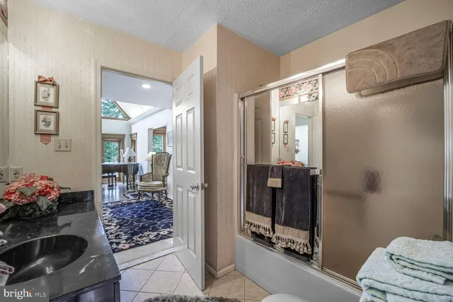 a bedroom with a bed dresser and a large mirror