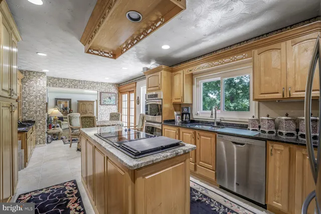 a kitchen with granite countertop a sink stove and cabinets