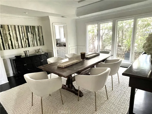 a dining room with furniture a large window and a table