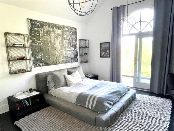 a bedroom with a bed couch and window