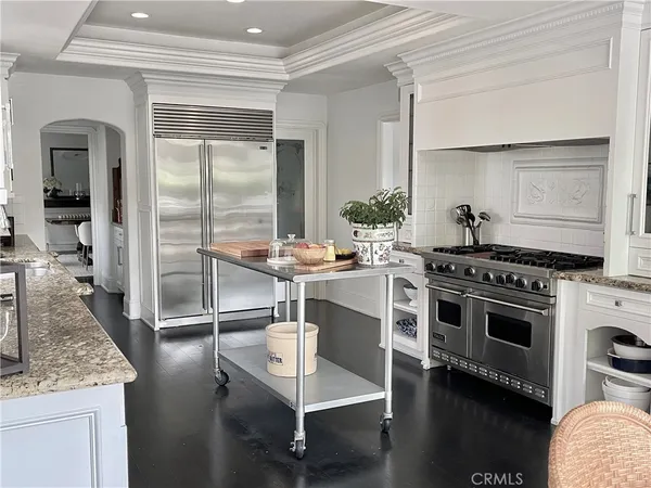 a kitchen with kitchen island a counter appliances a sink and cabinets