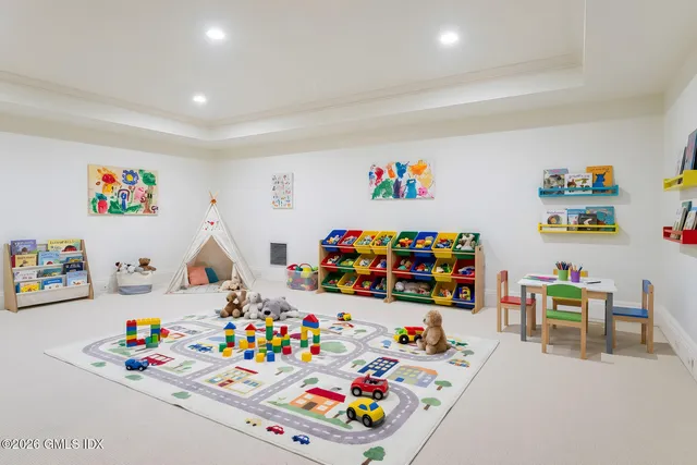a living room with patio furniture and a floor to ceiling window