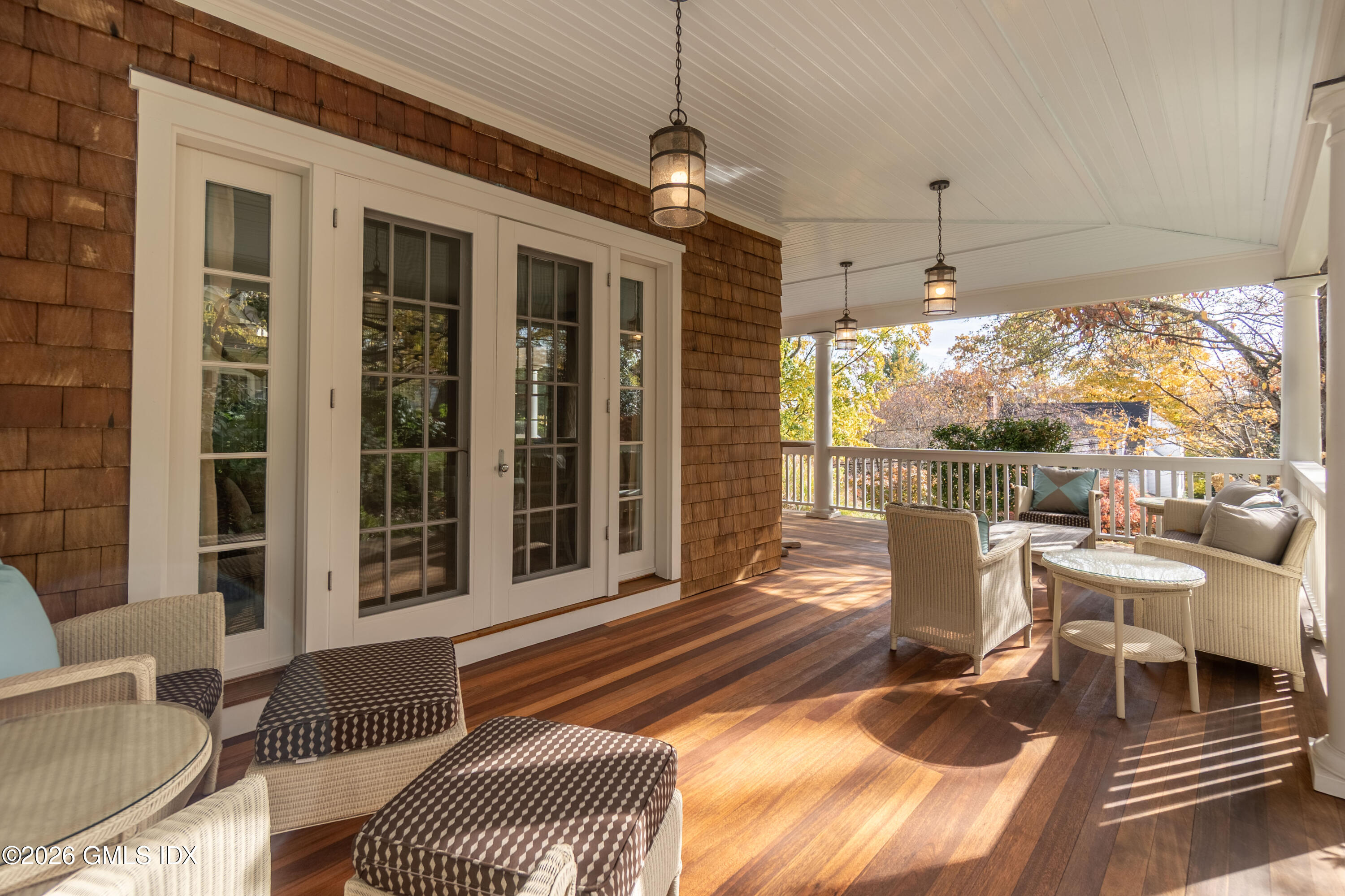 63 Wesskum Wood Road Riverside, CT 06878 - Photo 22 of 26 a living room with patio furniture and a floor to ceiling window