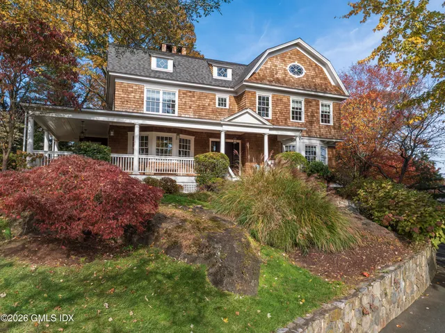 a front view of a house with a garden