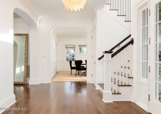 a view of entryway and hall with wooden floor