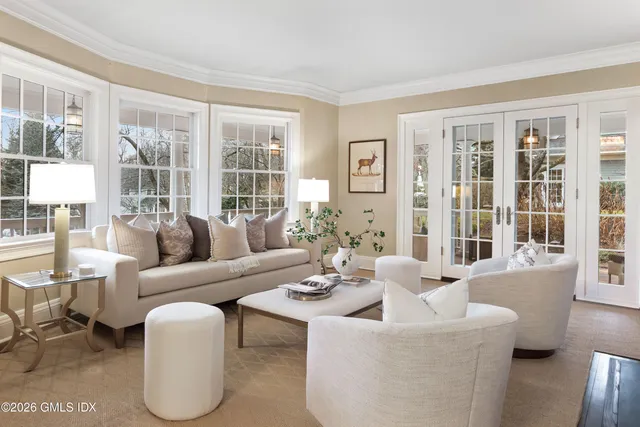 a living room with furniture and floor to ceiling windows