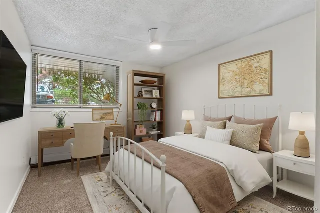 a bedroom with a bed and a large window