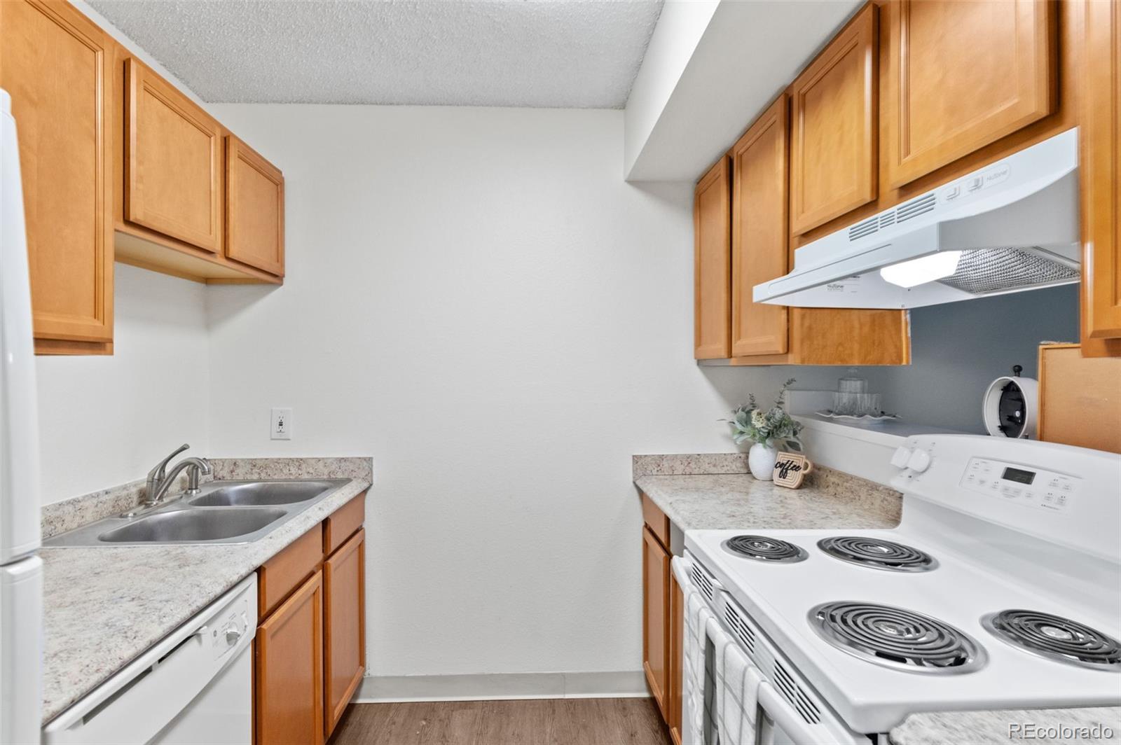 2707 Valmont Road, Unit 106 Boulder, CO 80304 - Photo 7 of 38 a kitchen with a sink stove top oven and cabinets