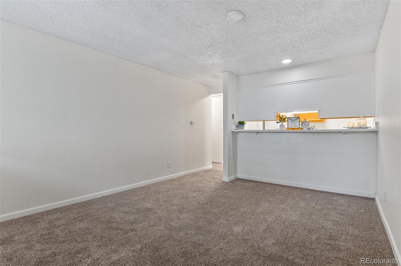 2707 Valmont Road, Unit 106 Boulder, CO 80304 - Photo 10 of 38 a view of a room with wooden floor and white walls