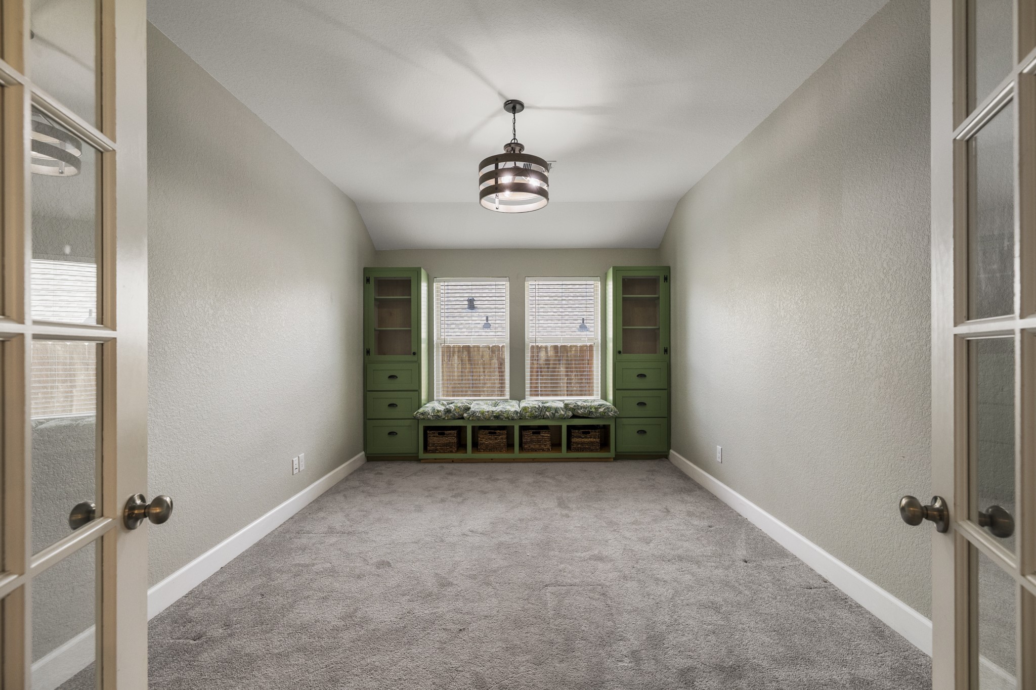 12340 Delta Timber Road Conroe, TX 77304 - Photo 22 of 41 The office features french doors, custom cabinetry and widow seating area.