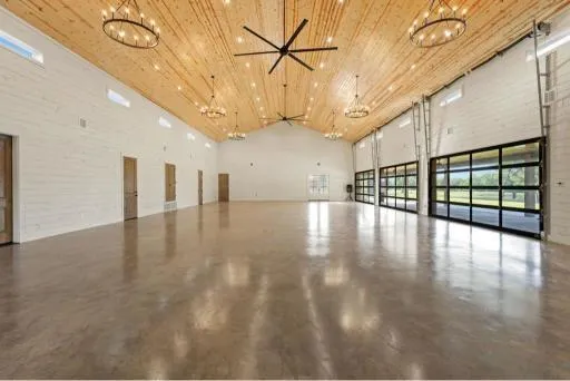 a view interior of a building with pool table and chairs