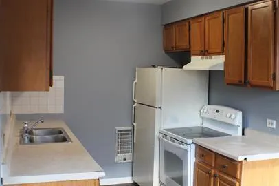a kitchen with a refrigerator and a sink
