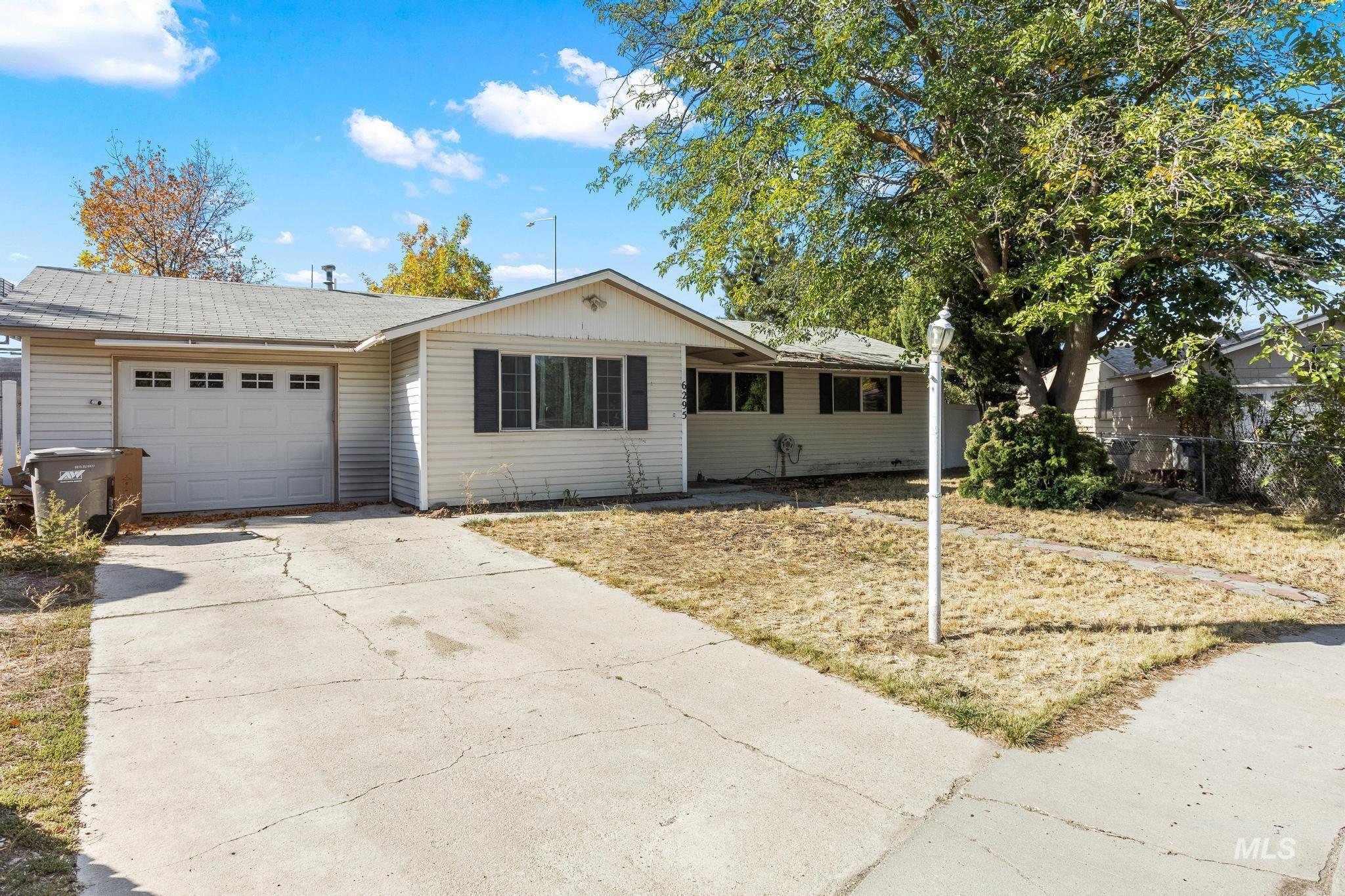 Single story home with a garage and concrete driveway