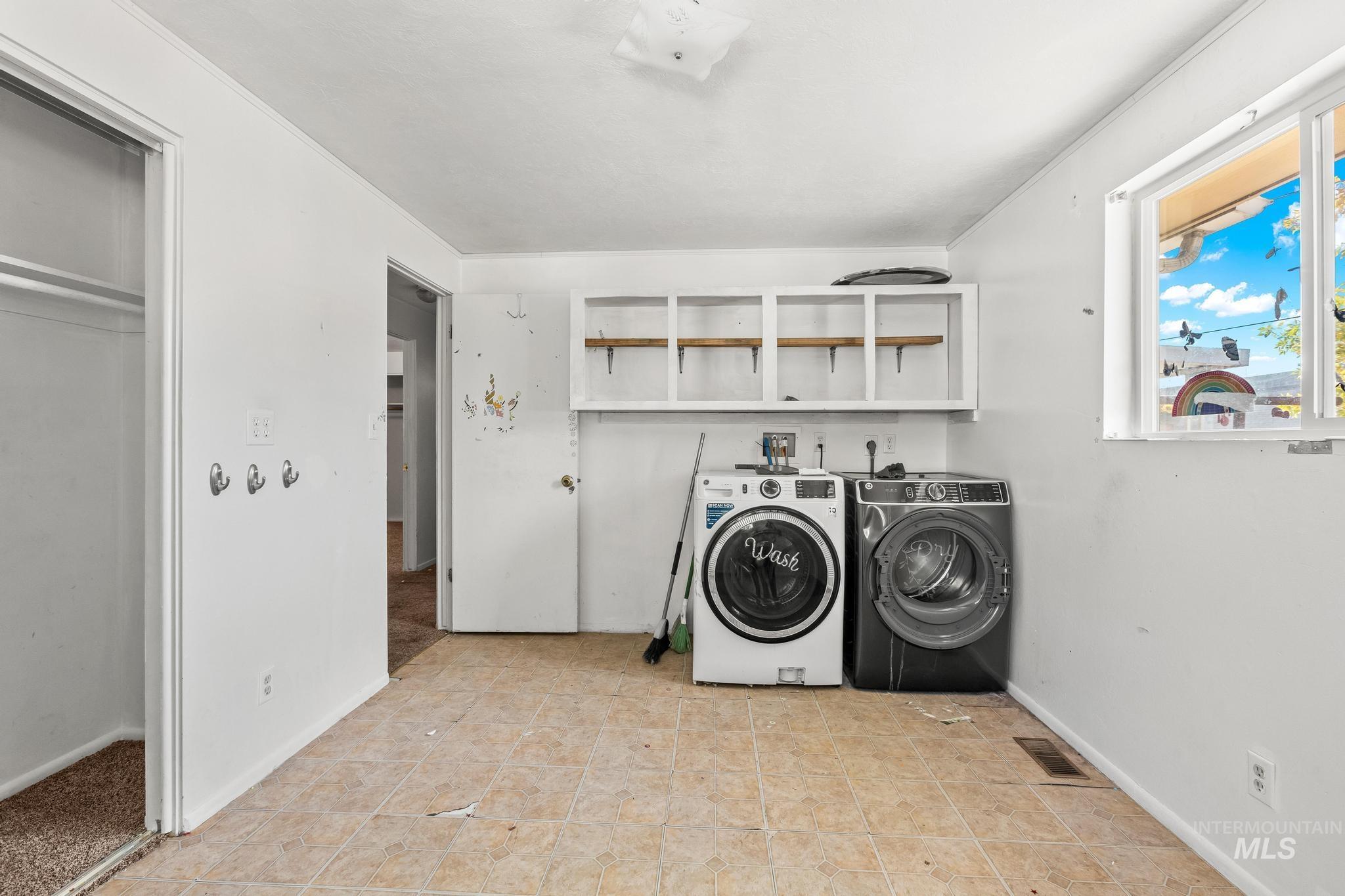 6295 West Grandview Place Boise, ID 83709 - Photo 14 of 29 Laundry room with washer and dryer and light tile patterned flooring