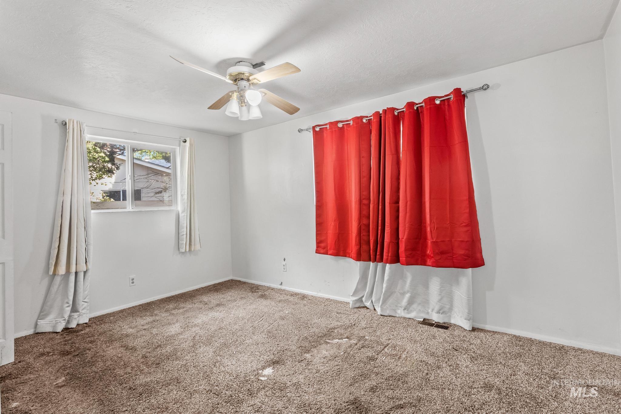 6295 West Grandview Place Boise, ID 83709 - Photo 19 of 29 Spare room featuring ceiling fan and carpet floors