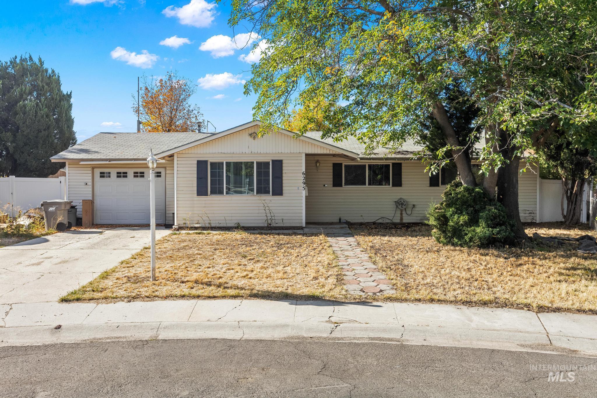 6295 West Grandview Place Boise, ID 83709 - Photo 2 of 29 Ranch-style home with concrete driveway, an attached garage, and a shingled roof