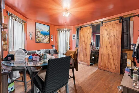 a dining room with furniture and a window