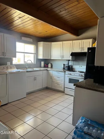 a kitchen with a sink a window and cabinets