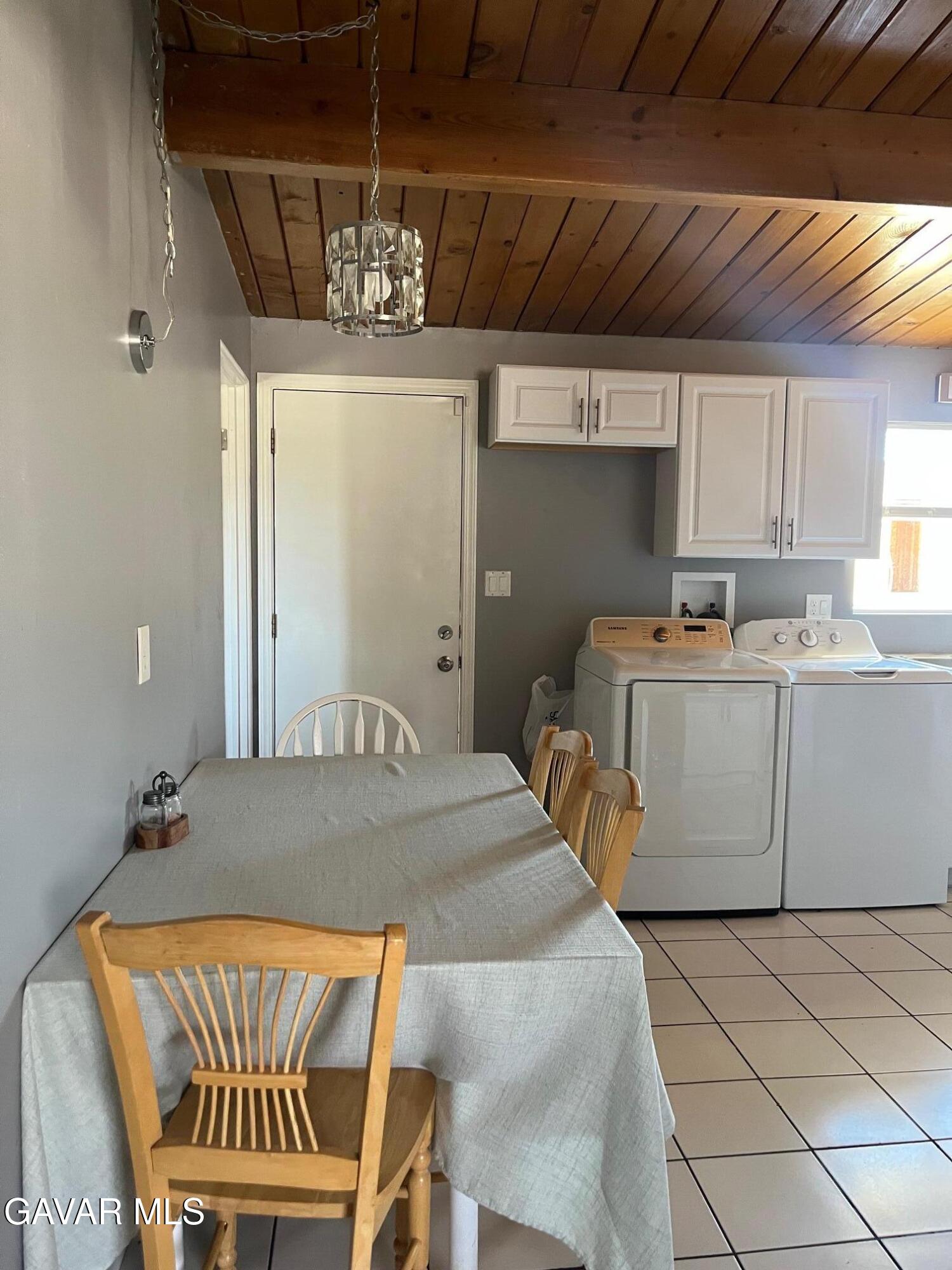 3354 Arthur Avenue Mojave, CA 93501 - Photo 7 of 12 a bedroom with a bed and a chandelier