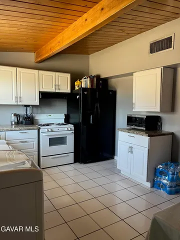 a kitchen with a refrigerator and a stove