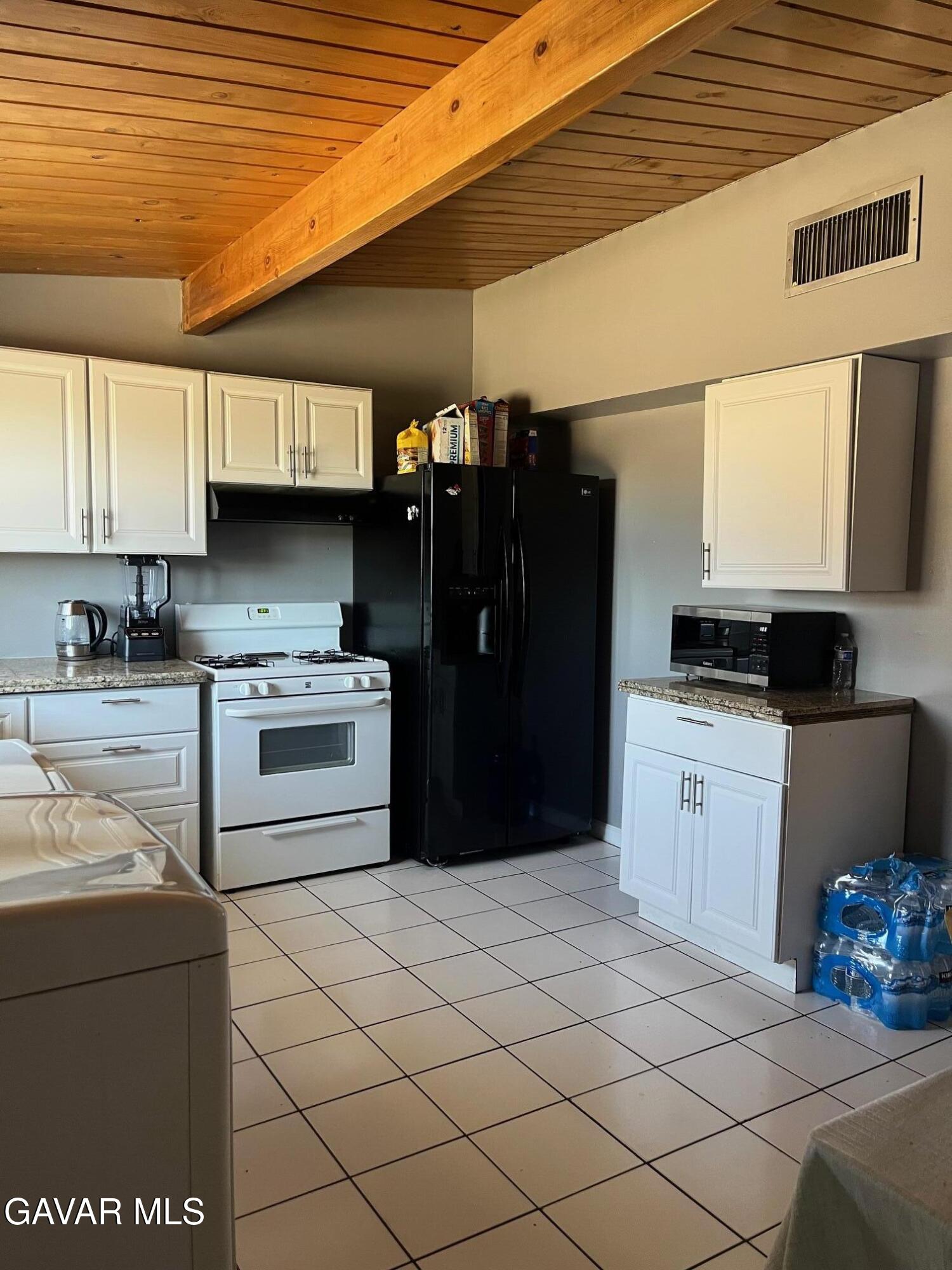 3354 Arthur Avenue Mojave, CA 93501 - Photo 8 of 12 a kitchen with a refrigerator and a stove