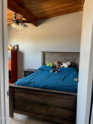 a bed sitting in a bedroom next to a cabinet