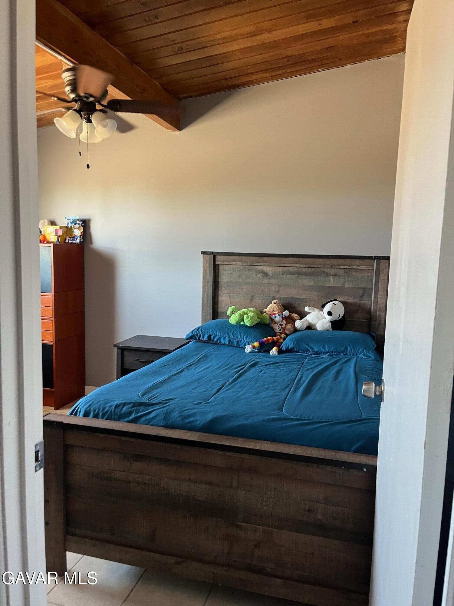 3354 Arthur Avenue Mojave, CA 93501 - Photo 10 of 12 a bed sitting in a bedroom next to a cabinet