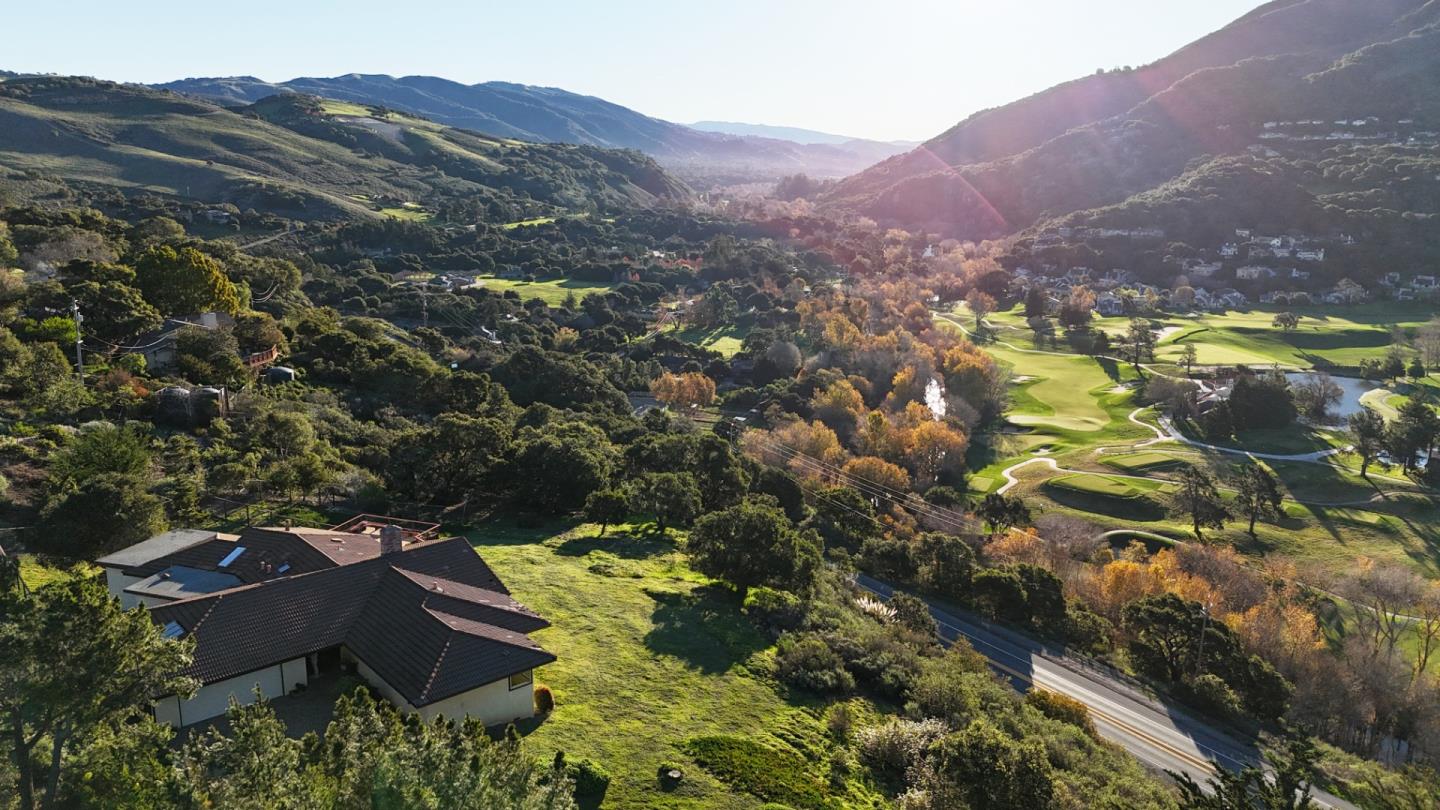 a view of a lush green hillside and a houses