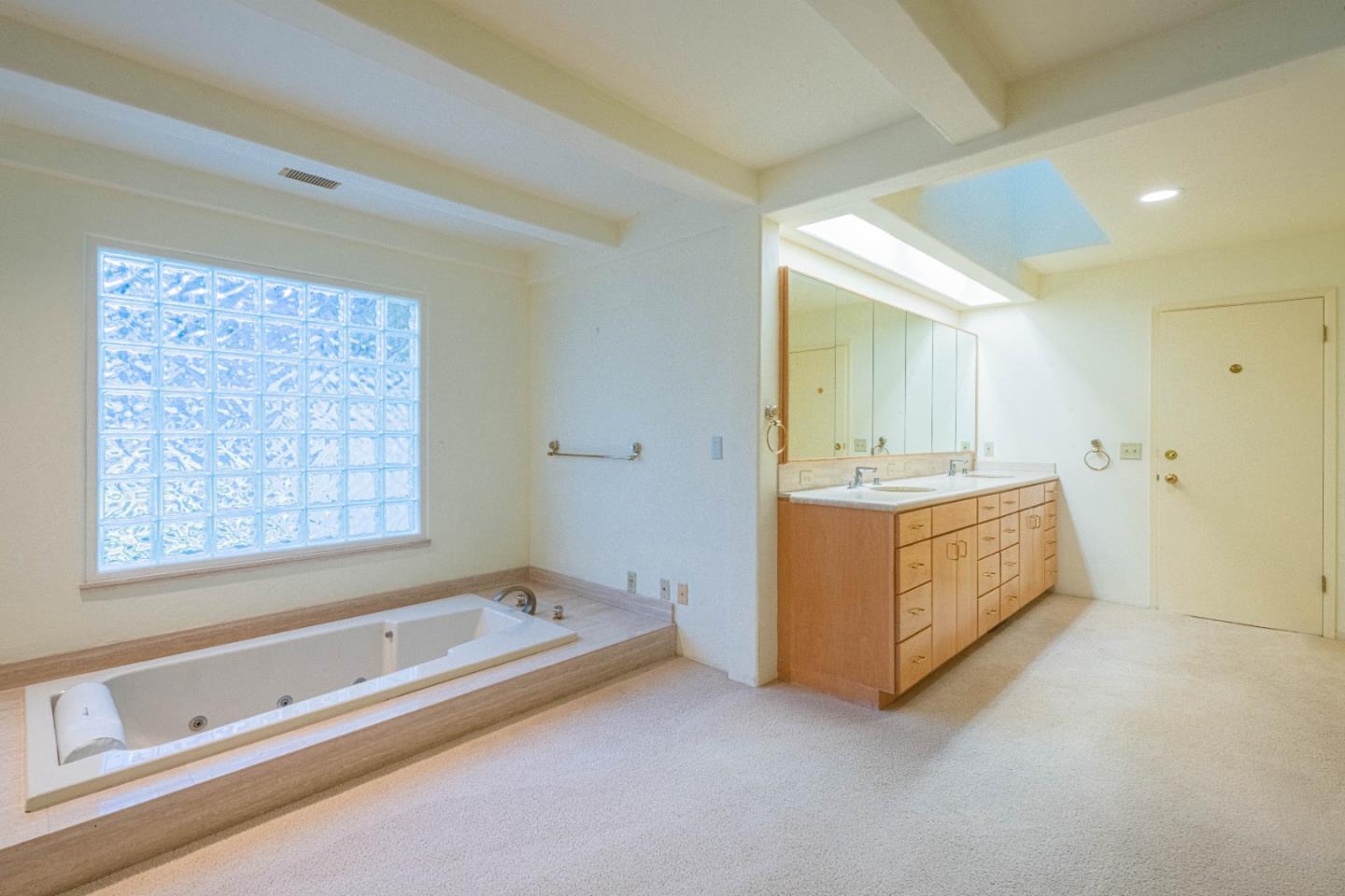 10000 Eddy Road Carmel, CA 93923 - Photo 26 of 37 a spacious bathroom with a double vanity sink a mirror and a bathtub