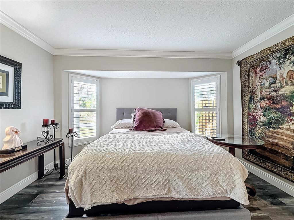 2686 Southwest Fairgreen Road Port St. Lucie, FL 34987 - Photo 14 of 36 a bedroom with a bed and window