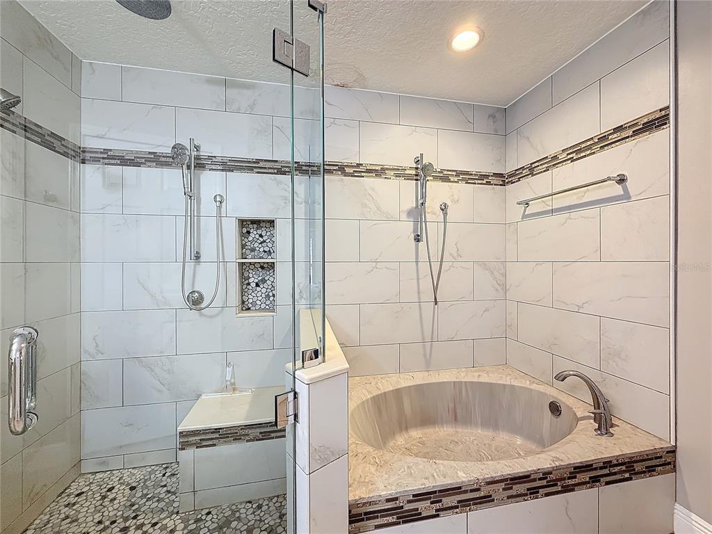2686 Southwest Fairgreen Road Port St. Lucie, FL 34987 - Photo 16 of 36 a bathroom with a granite countertop bathtub shower and toilet