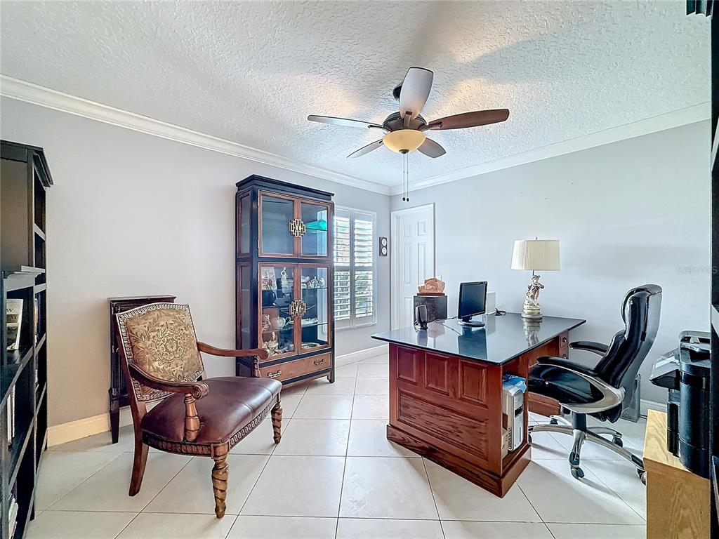 2686 Southwest Fairgreen Road Port St. Lucie, FL 34987 - Photo 18 of 36 a living room with furniture a piano and a window