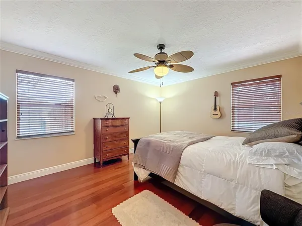 a bedroom with a bed and a chandelier