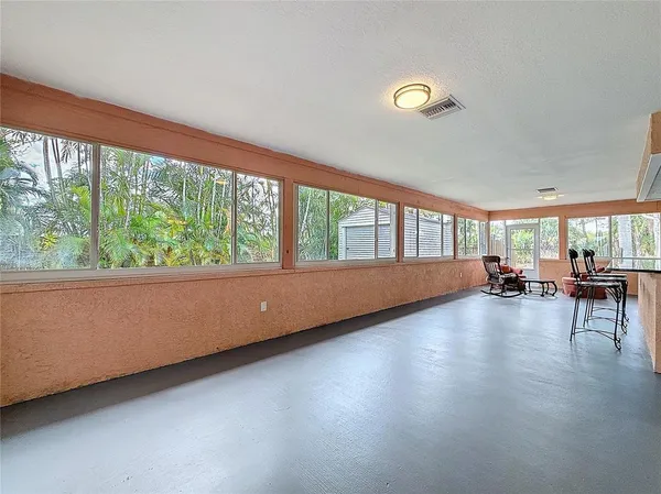 a view of room with hardwood floor and a large window