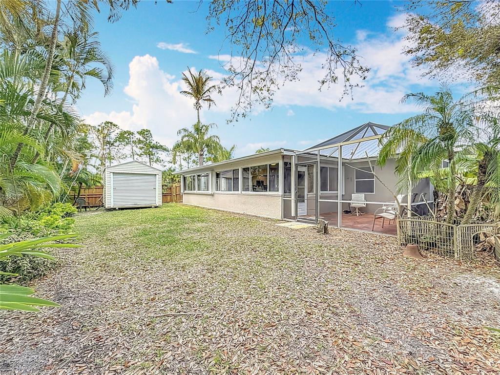 2686 Southwest Fairgreen Road Port St. Lucie, FL 34987 - Photo 29 of 36 a front view of a house with a garden