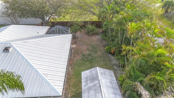 an aerial view of residential houses with outdoor space and swimming pool