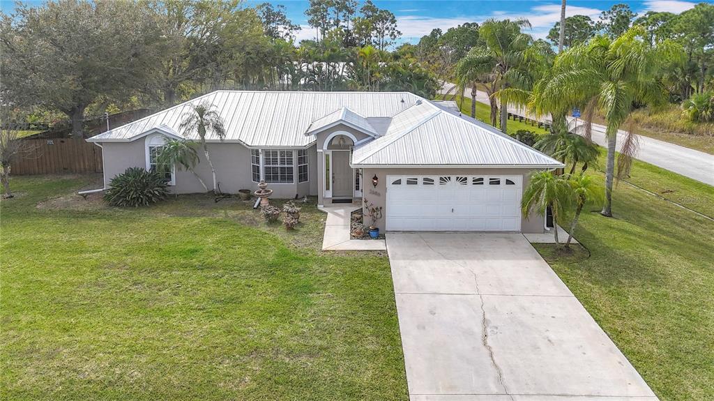 2686 Southwest Fairgreen Road Port St. Lucie, FL 34987 - Photo 35 of 36 a view of a back yard of the house