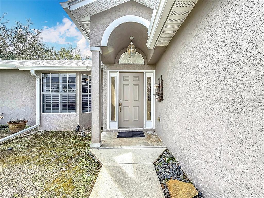2686 Southwest Fairgreen Road Port St. Lucie, FL 34987 - Photo 4 of 36 a front view of a house with a rug