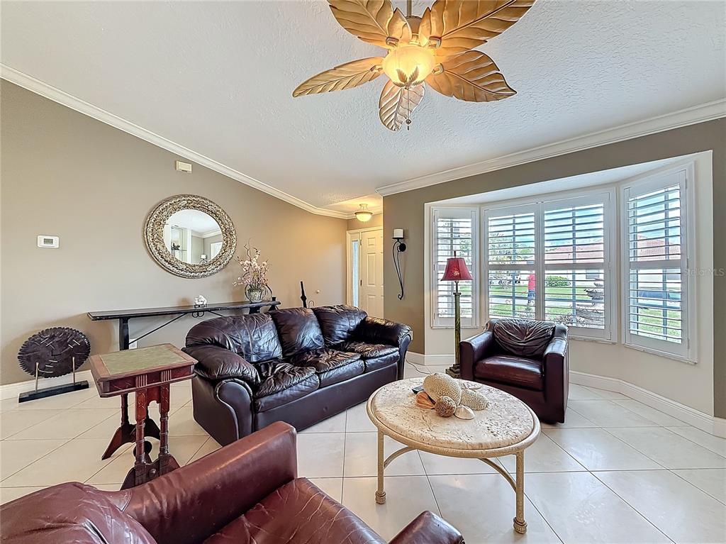 2686 Southwest Fairgreen Road Port St. Lucie, FL 34987 - Photo 7 of 36 a living room with furniture and a large window