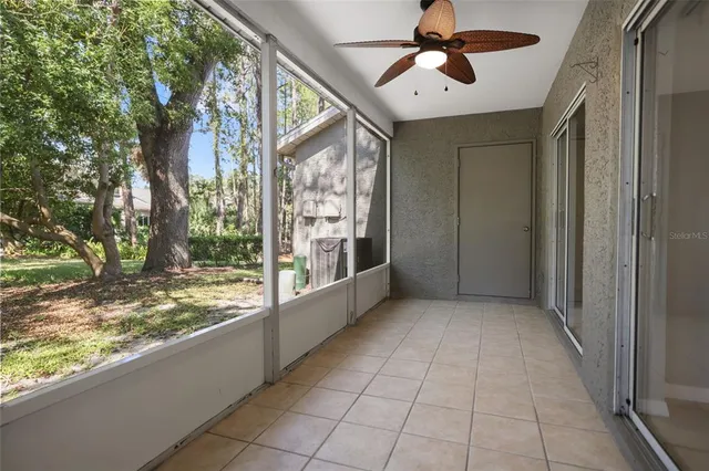 a view of backyard with window and a ceiling fan