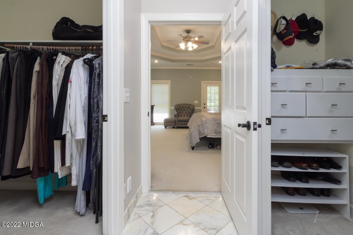 331 Country Creek Road Macon, GA 31220 - Photo 16 of 36 a view of walk in closet with clothes and shoes