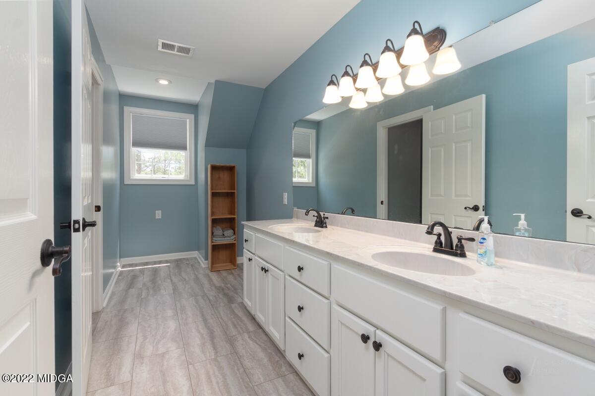 331 Country Creek Road Macon, GA 31220 - Photo 21 of 36 a bathroom with a double vanity sink and a mirror
