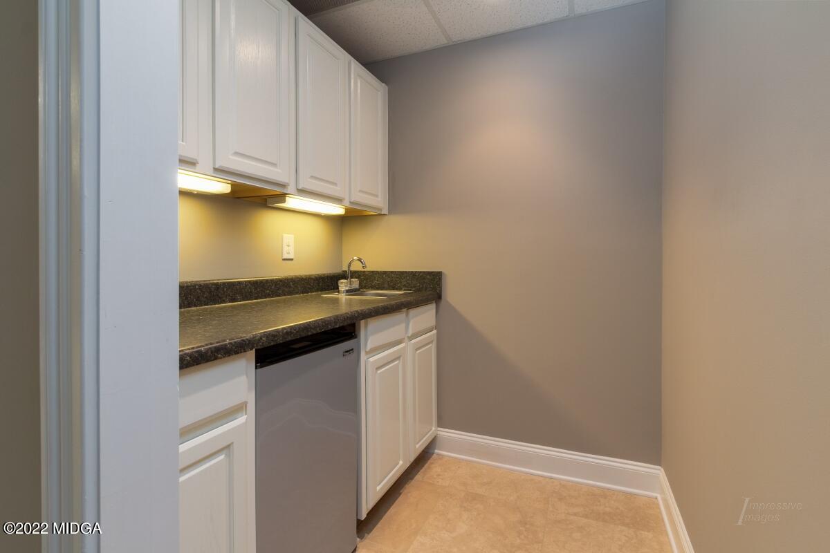 331 Country Creek Road Macon, GA 31220 - Photo 27 of 36 a kitchen with a sink and cabinets