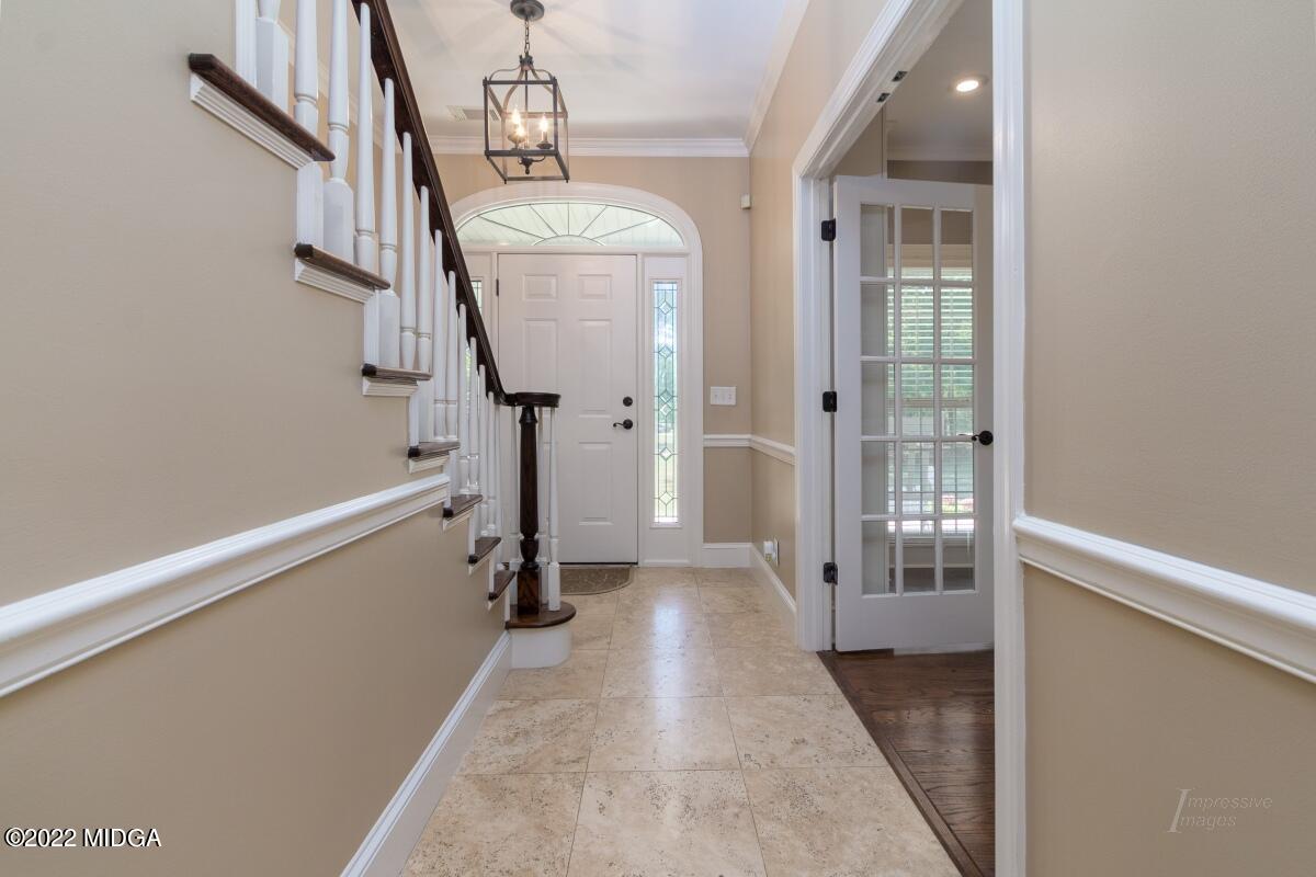 331 Country Creek Road Macon, GA 31220 - Photo 3 of 36 a view of hallway with stairs and a wooden floor