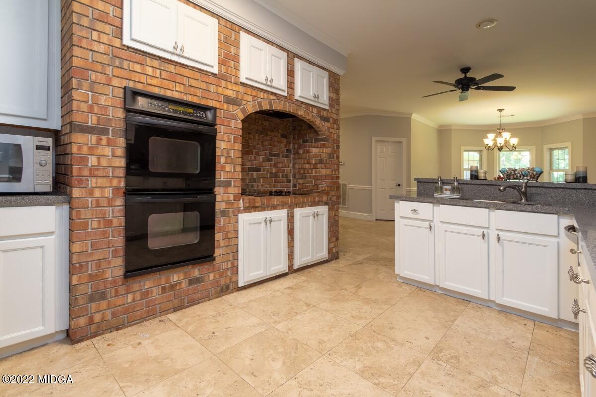 331 Country Creek Road Macon, GA 31220 - Photo 9 of 36 a kitchen with stainless steel appliances granite countertop a stove a sink and a refrigerator