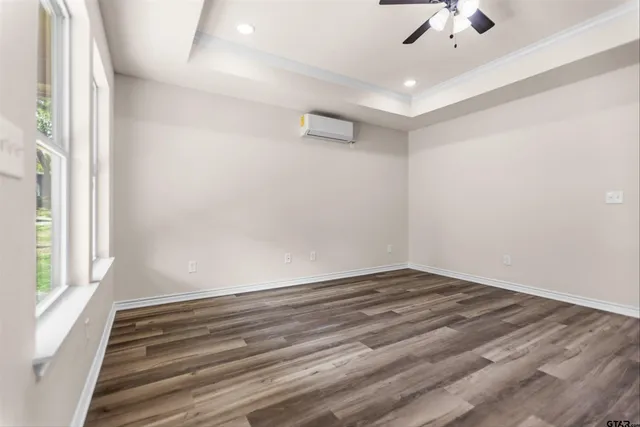 wooden floor in an empty room with a window
