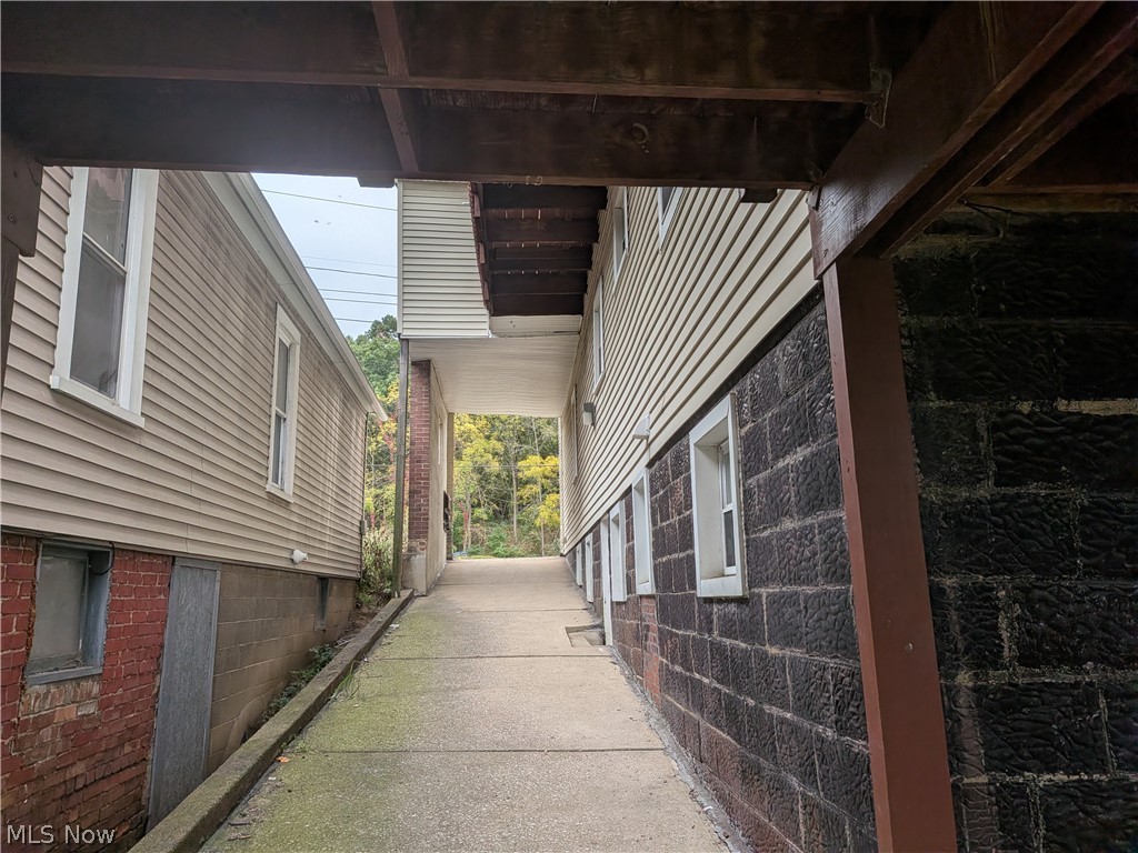1881 Manchester Road, Unit 1 Akron, OH 44314 - Photo 36 of 44 1881 Manchester Rd, Akron, OH 44314 Unit #1 ground floor access and living. Welcome to this spacious 2-bedroom, 1-bathroom first-floor generous and remodeled apartment in the Kenmore neighborhood of Akron, offering a great amount of comfortable living space. This move-in ready apartment features LVP flooring throughout, a spacious living room, room for dining, separate kitchen with a gas range and stainless steel refrigerator, two bedrooms, and a full private bathroom which has a convenient step-in shower. Large windows provide natural light, while ample closets offer plenty of storage. Enjoy off-street parking and a backyard with a picnic table and small firepit, providing a pleasant outdoor space to relax and enjoy for the buildings tenants.