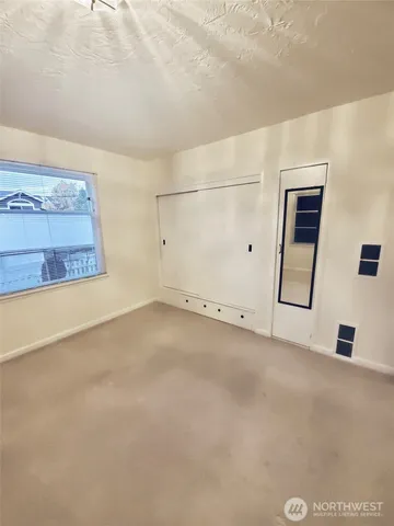 a view of empty room with a fireplace